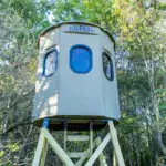 Close up of Tree Trunk Poplar Gun XT Blind with trap door and gun windows sitting in woods