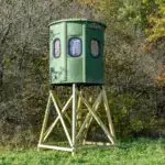 Poplar Gun XT Blind in Forest Green with gun windows and trap door set by edge of woods