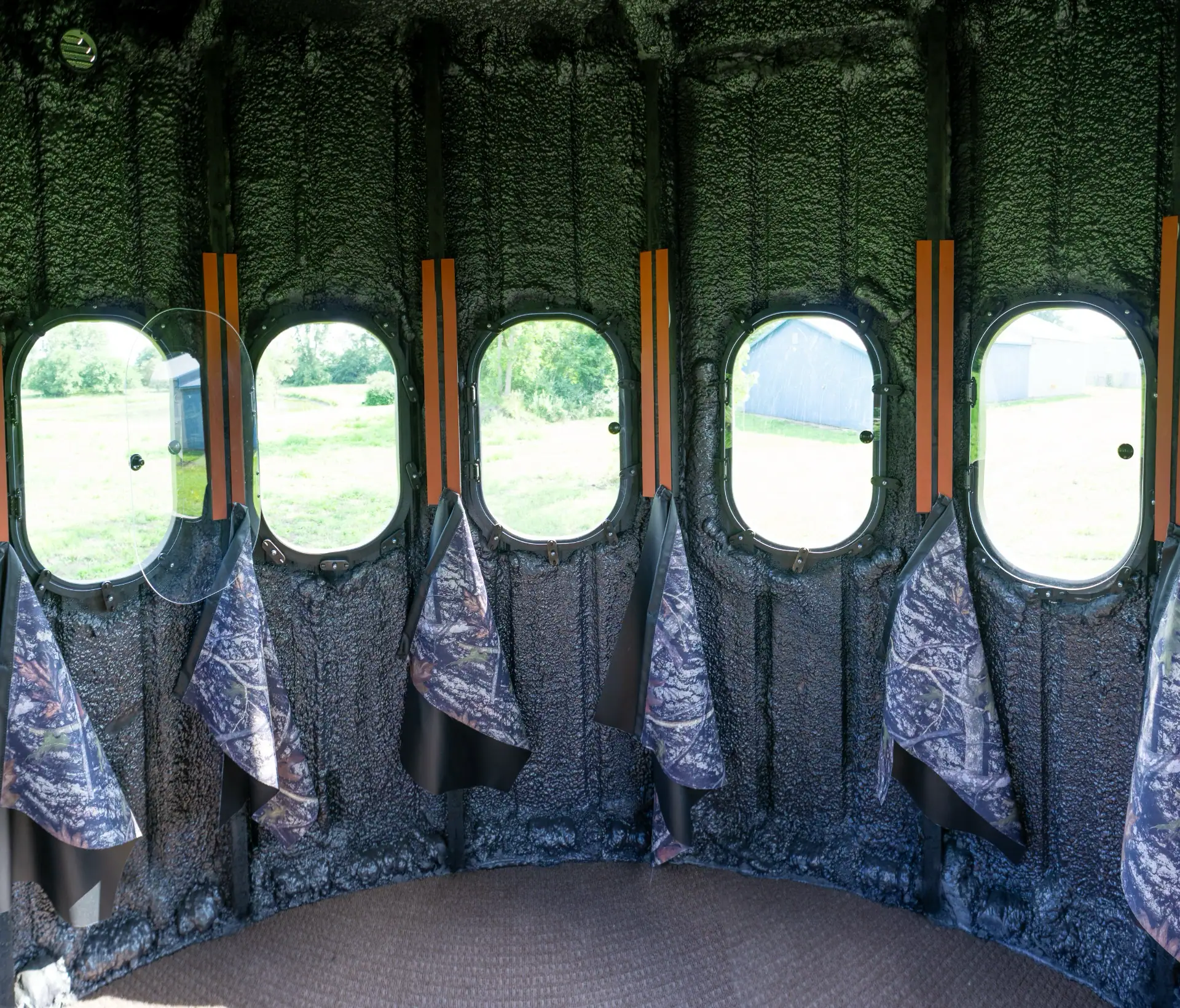 Inside The Ultimate Blind with 360 degree view outside with curtains hanging below windows