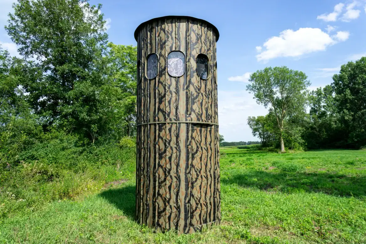 The Ultimate Blind set in a grassy field with trees in the background