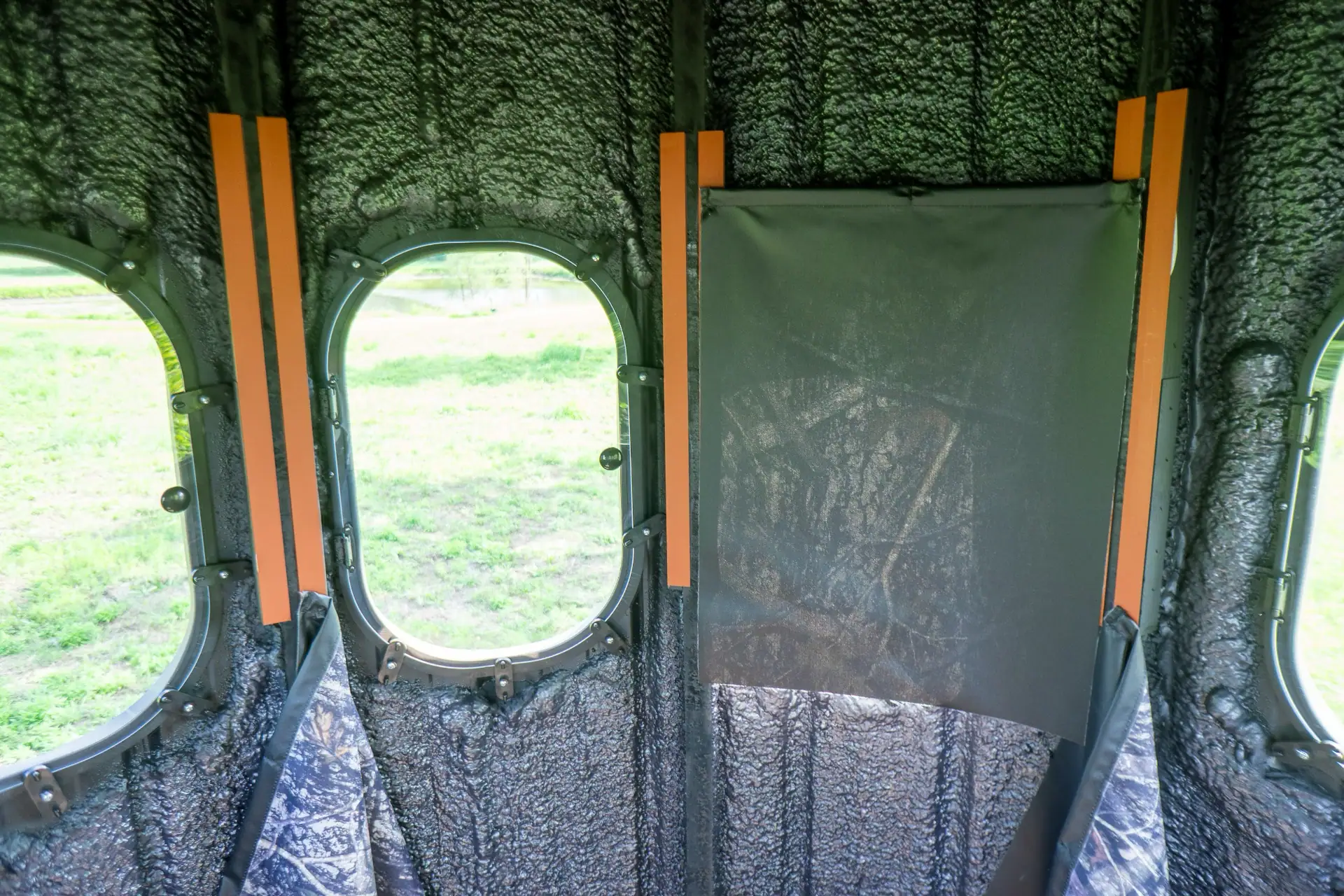 The Ultimate Blind from inside with one window covered with a curtain