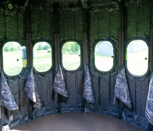 Inside The Ultimate Blind with 360 degree view outside with curtains hanging below windows
