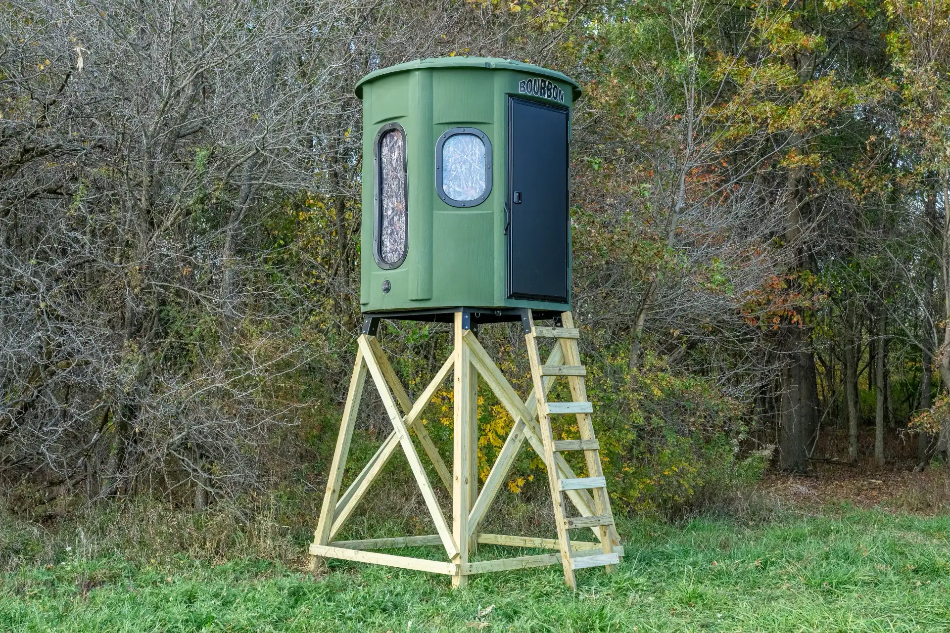 White Oak XT Blind in Forest Green with combo gun and bow windows and side door set by edge of woods