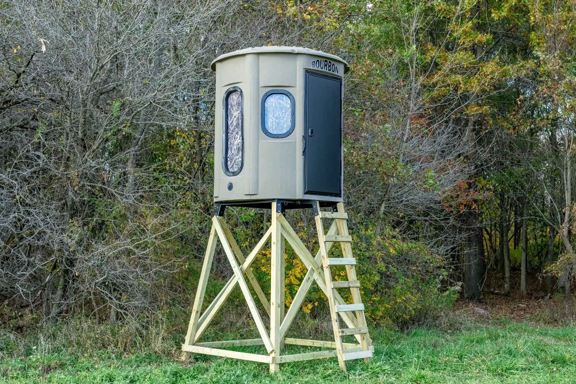 White Oak XT Blind in Tree Trunk color with combo gun and bow windows and side door set by edge of woods