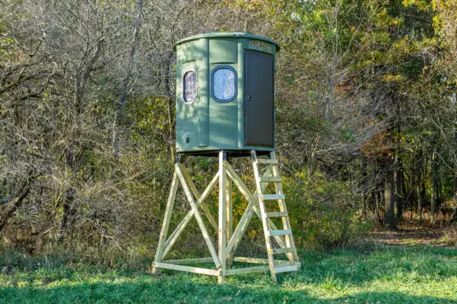 White Oak XT Blind in Forest Green with gun windows and side door set by edge of woods