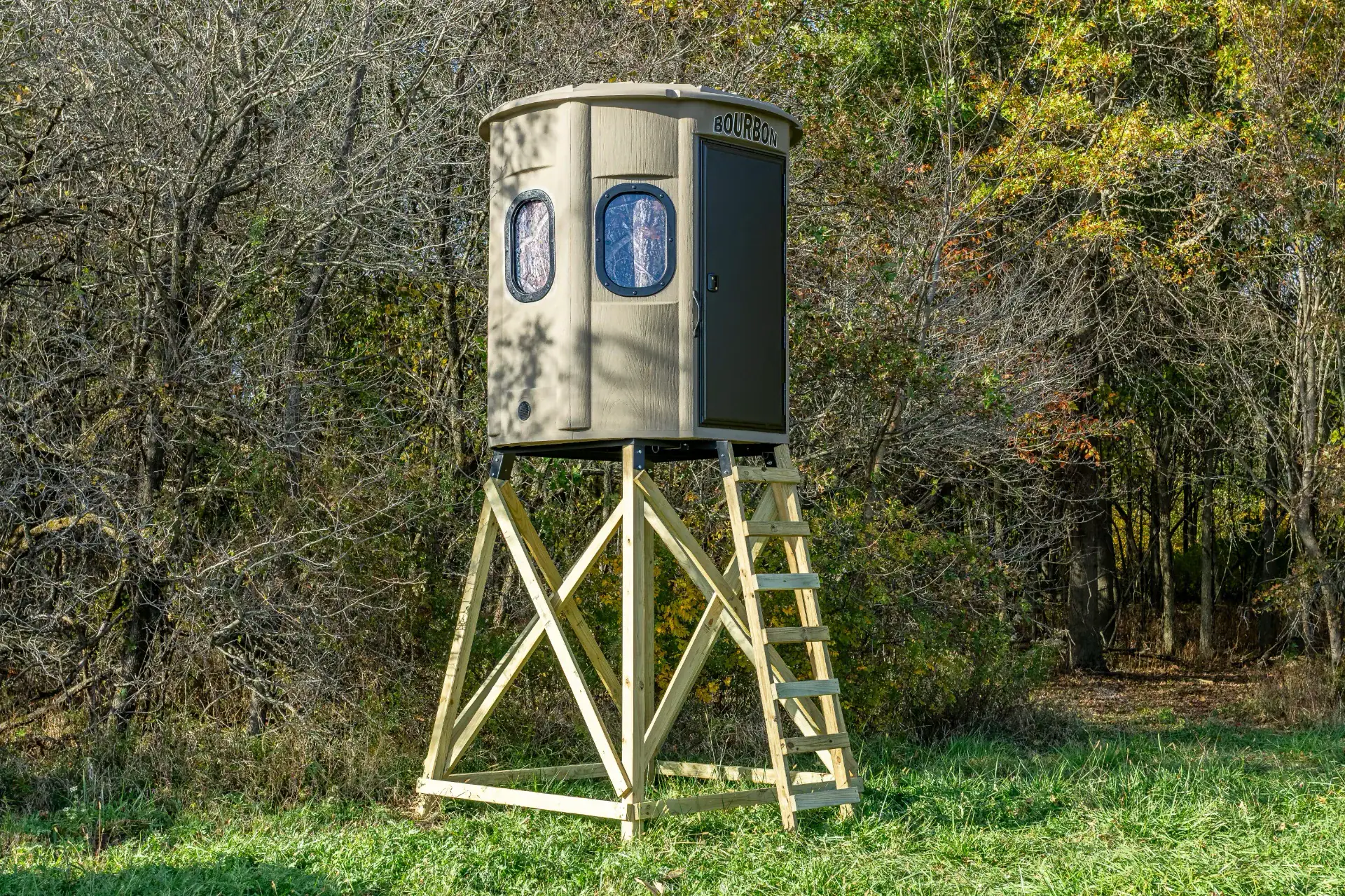 White Oak XT Blind in Tree Trunk color with gun windows and side door set by edge of woods