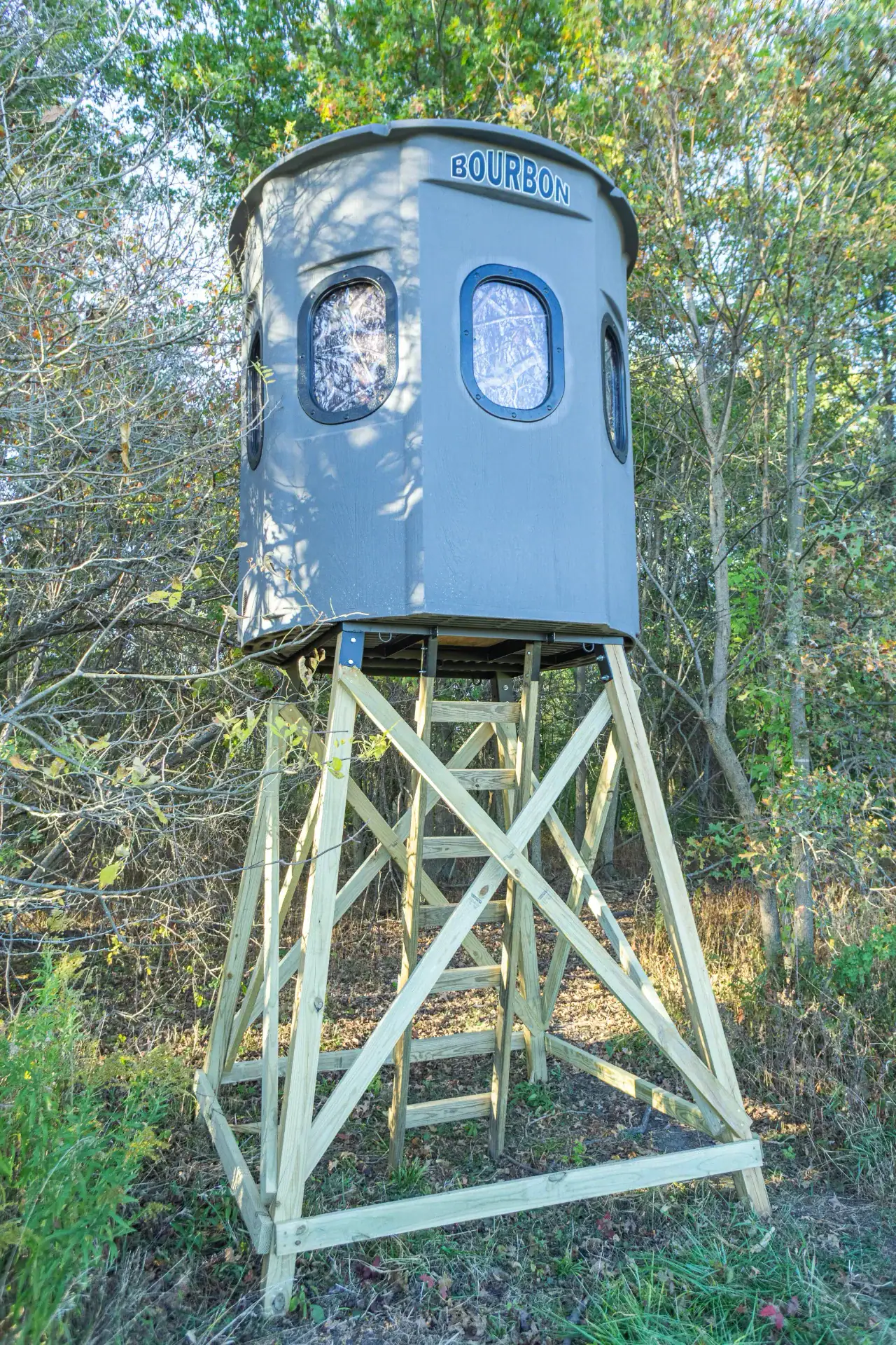 Alt corner view of Poplar Gun XT Blind on elevated stand in woods